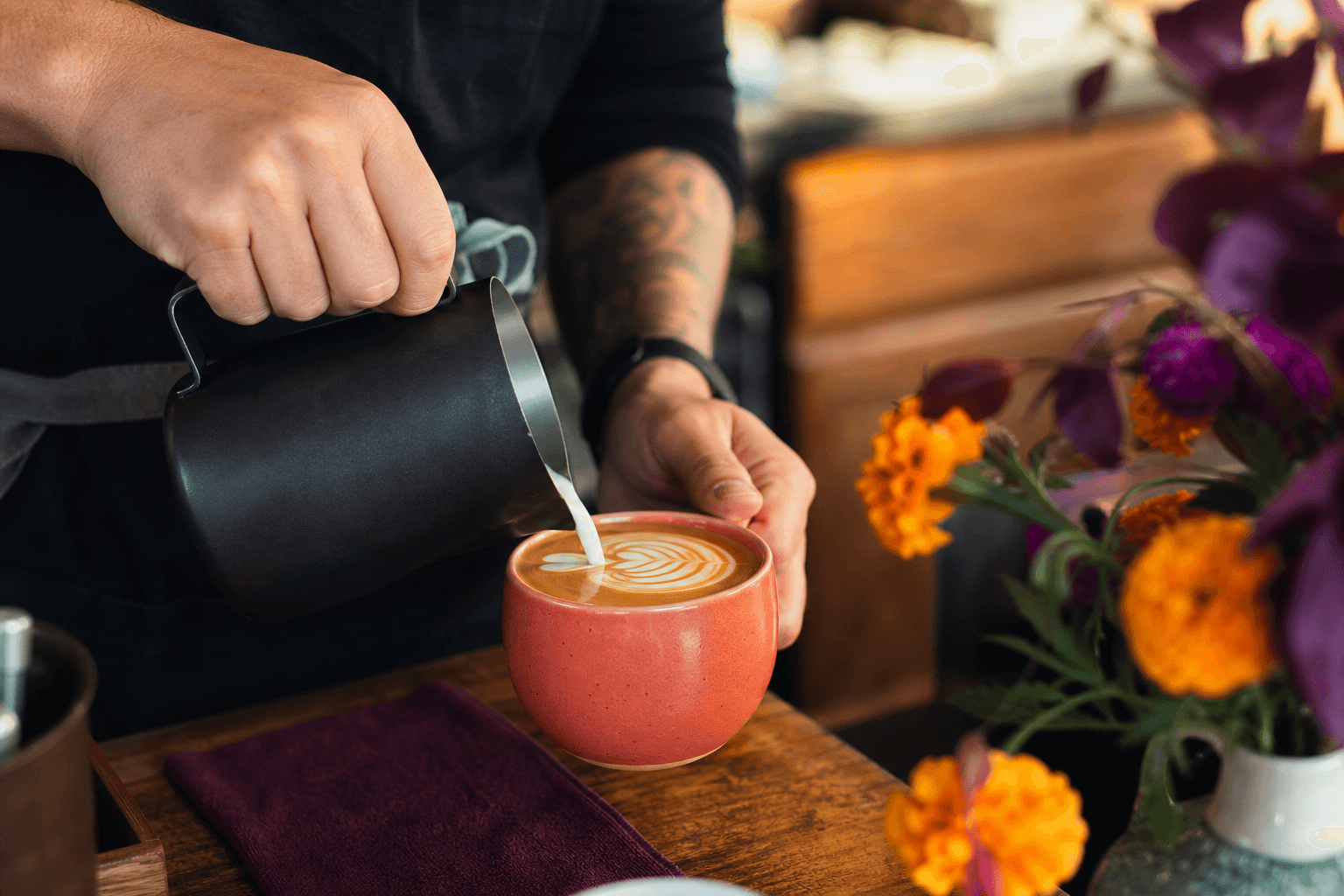 A barista pouring latte art