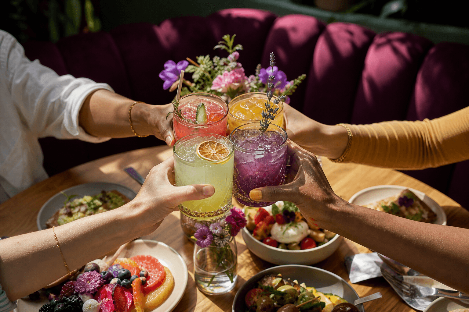 Friends celebrating over colourful drinks